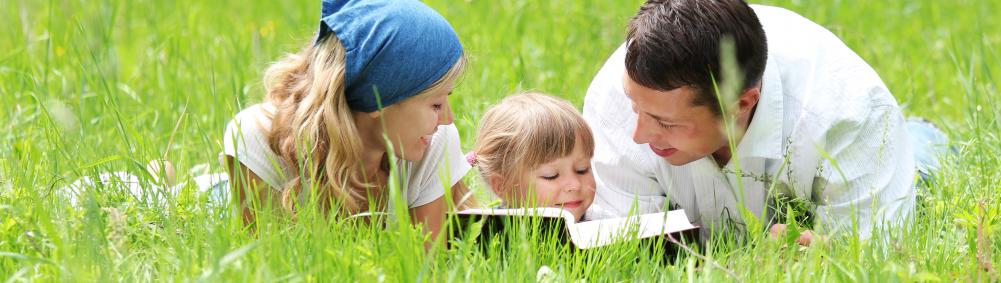 young family with daughter reads Bible